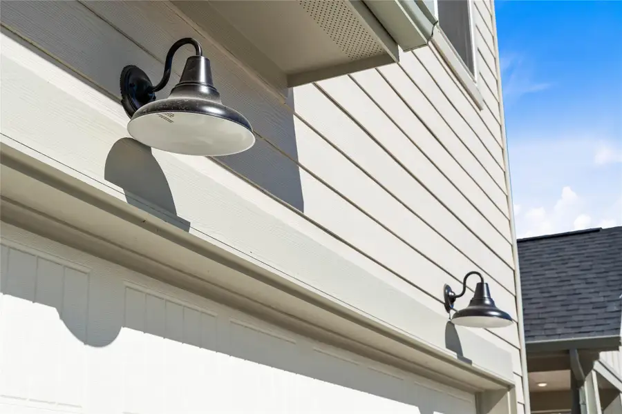 The property features stylish matte black gooseneck barn lights - providing ample illumination for safety and ambiance.