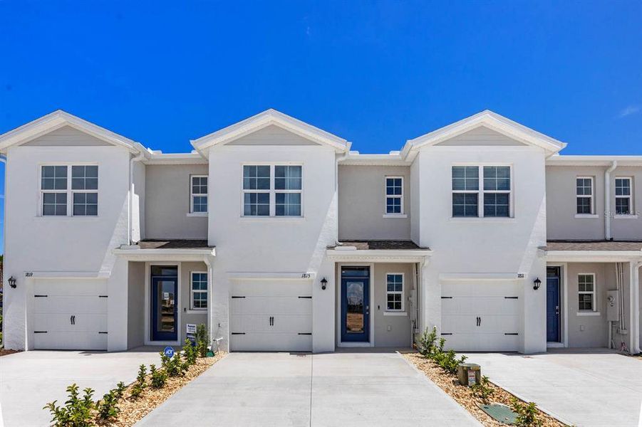 Front exterior of a new home in , Haines City, FL, highlighting curb appeal (Image 1). Front exterior of a new home in , Haines City, FL, highlighting curb appeal (Image 1).