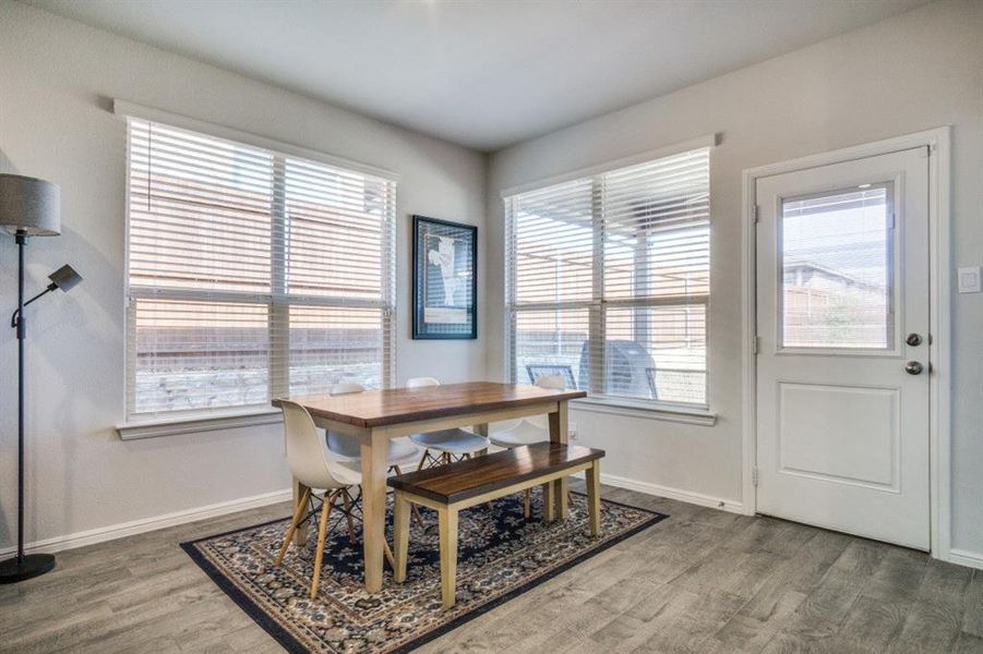 Dining space with wood finished floors and baseboards