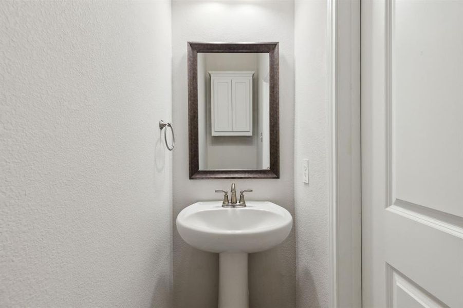 This half bath is located across from the laundry room and near the open family room. This half bath is located across from the laundry room and near the open family room.