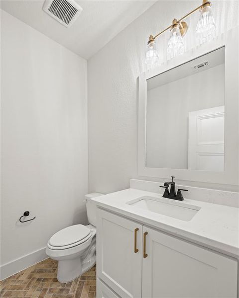 Bathroom featuring vanity and brick patterned flooring