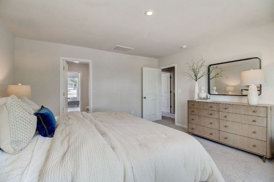 A bedroom with a bed and dresser. A bedroom with a bed and dresser.