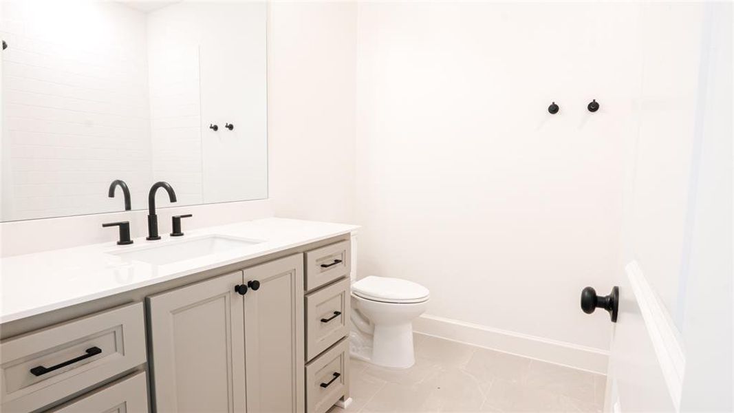 Kitchen featuring backsplash, arched walkways, light wood-style flooring, custom range hood, and recessed lighting Kitchen featuring backsplash, arched walkways, light wood-style flooring, custom range hood, and recessed lighting