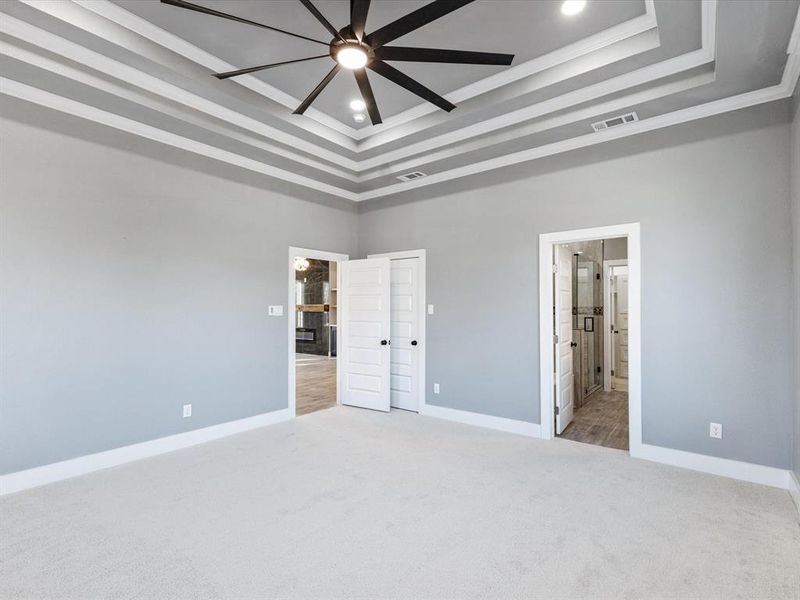 Unfurnished bedroom with light colored carpet, recessed lighting, ensuite bath, and ceiling fan Unfurnished bedroom with light colored carpet, recessed lighting, ensuite bath, and ceiling fan