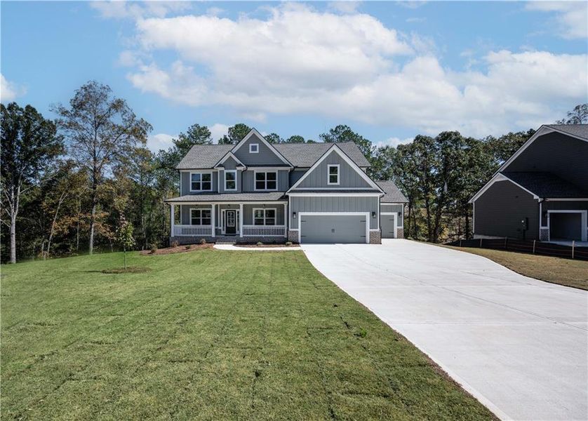 Front exterior of a new home in Woodland Hills, Loganville, GA, highlighting curb appeal (Image 2). Front exterior of a new home in Woodland Hills, Loganville, GA, highlighting curb appeal (Image 2).