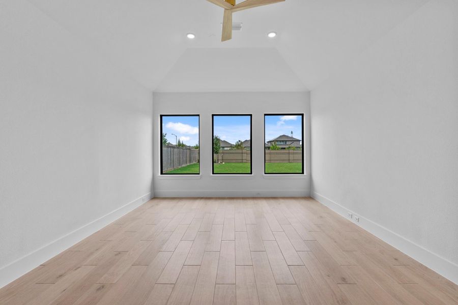 The spacious game room connects to a media room. Representative image.