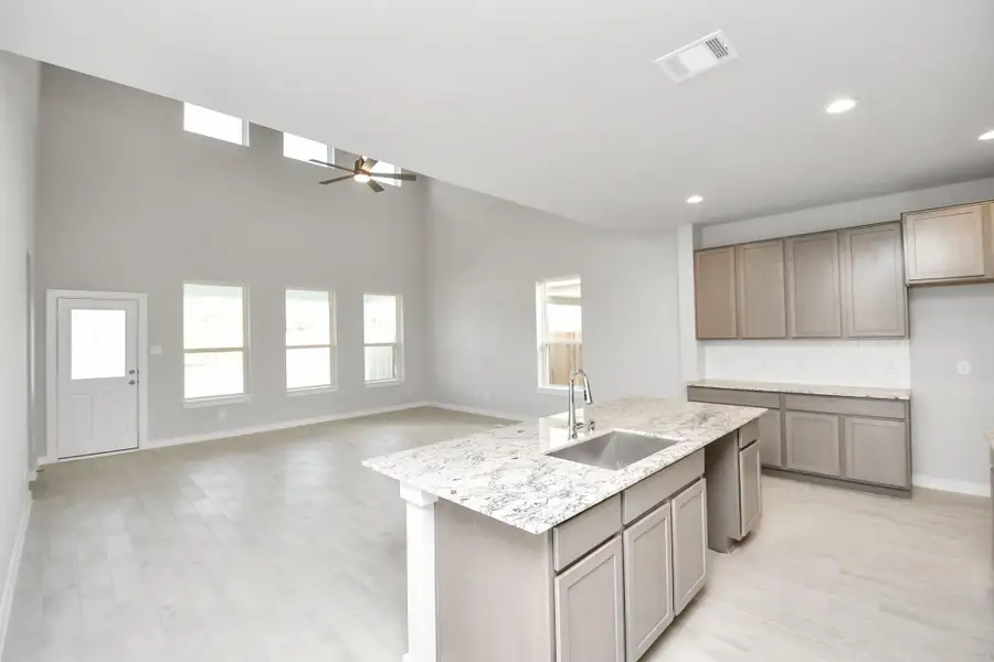 Discover another perspective of this spacious kitchen! Sample photo of completed home with similar floor plan. Actual colors and selections may vary.