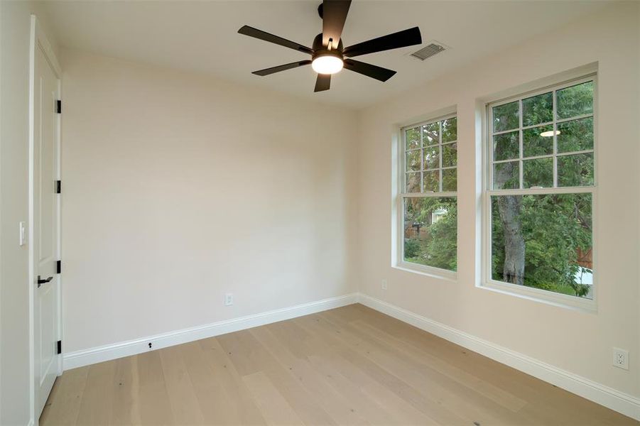 Spare room with ceiling fan and light hardwood / wood-style floors