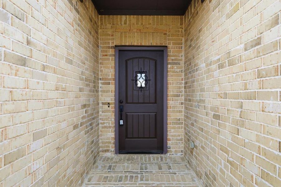 Entrance to property with brick siding
