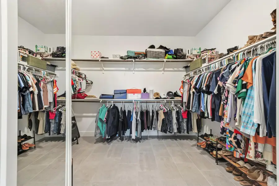 View of spacious primary closet View of spacious primary closet