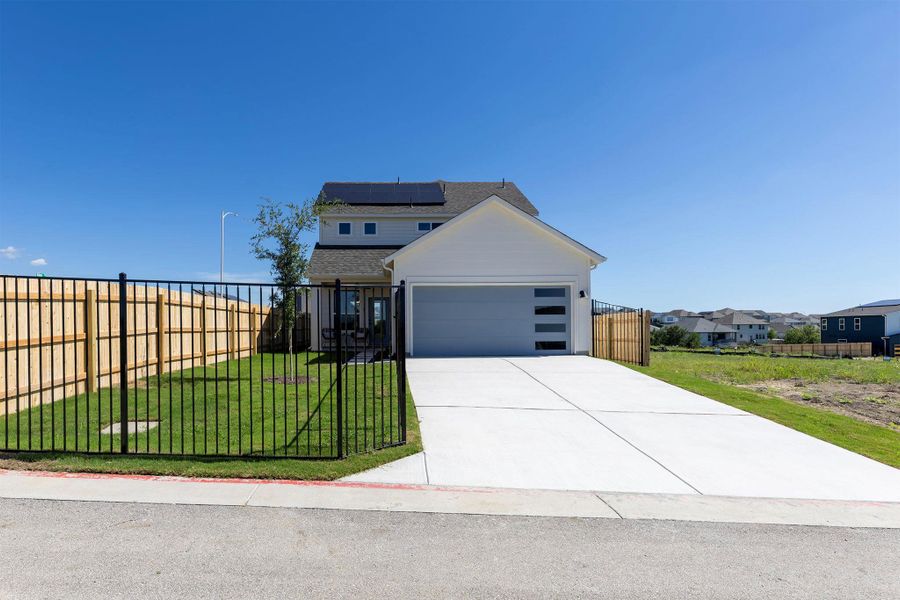 Front exterior of a new home in Whisper Valley, Manor, TX, highlighting curb appeal (Image 1). Front exterior of a new home in Whisper Valley, Manor, TX, highlighting curb appeal (Image 1).