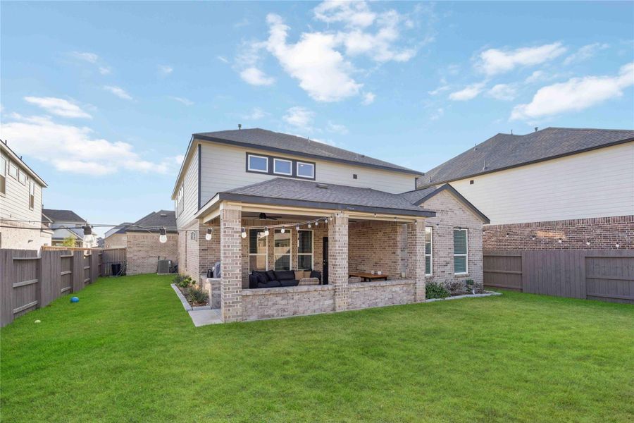 Covered back patio with added brick accents and custom enclosure features, giving it a more elevated and private outdoor living feel. Covered back patio with added brick accents and custom enclosure features, giving it a more elevated and private outdoor living feel.