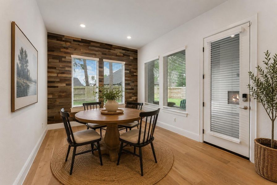 Breakfast nook highlighted by a custom accent wall and abundant natural light.(Furniture was virtually staged)