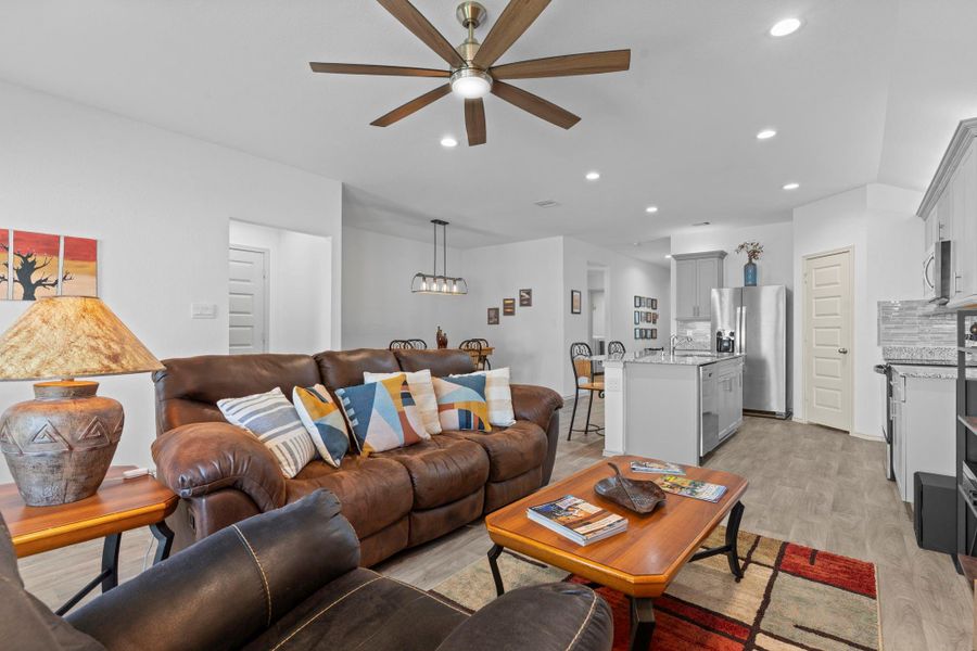 Inviting family room perspective looking back toward the kitchen and dining area — perfect for entertaining, with plenty of room to gather while enjoying the open, airy design. Tucked away on the left hallway you will discover the outstanding primary suite. Inviting family room perspective looking back toward the kitchen and dining area — perfect for entertaining, with plenty of room to gather while enjoying the open, airy design. Tucked away on the left hallway you will discover the outstanding primary suite.