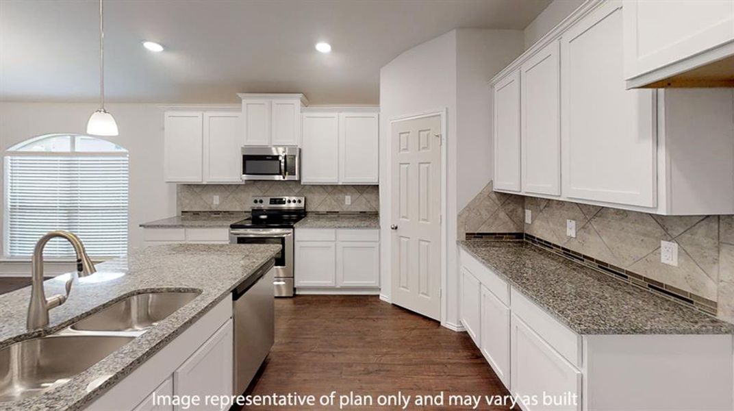 Kitchen featuring white cabinetry, dark wood-type flooring, stainless steel appliances, hanging light fixtures, and recessed lighting Kitchen featuring white cabinetry, dark wood-type flooring, stainless steel appliances, hanging light fixtures, and recessed lighting