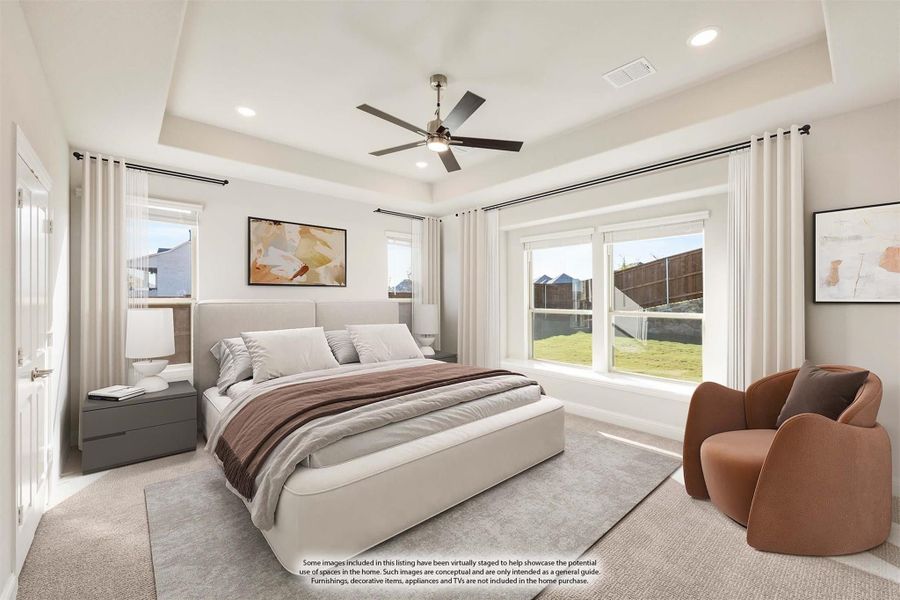 Master bedroom with tray ceiling, ceiling fan, large windows, and neutral carpet flooring Master bedroom with tray ceiling, ceiling fan, large windows, and neutral carpet flooring