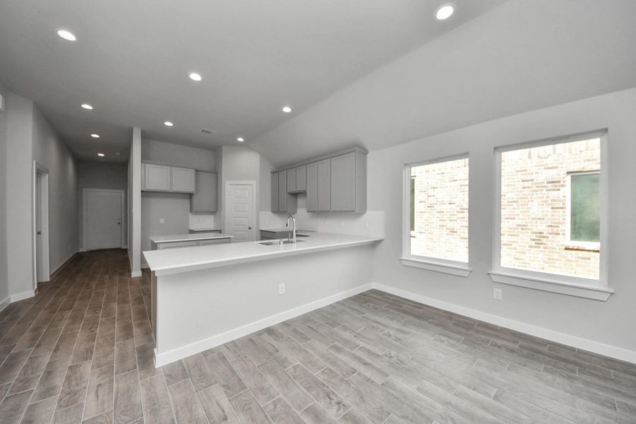 All of this overlooks your expansive family room, creating a perfect space for culinary delights and family gatherings. Sample photo of completed home with similar floor plan. Actual colors and selections may vary. All of this overlooks your expansive family room, creating a perfect space for culinary delights and family gatherings. Sample photo of completed home with similar floor plan. Actual colors and selections may vary.