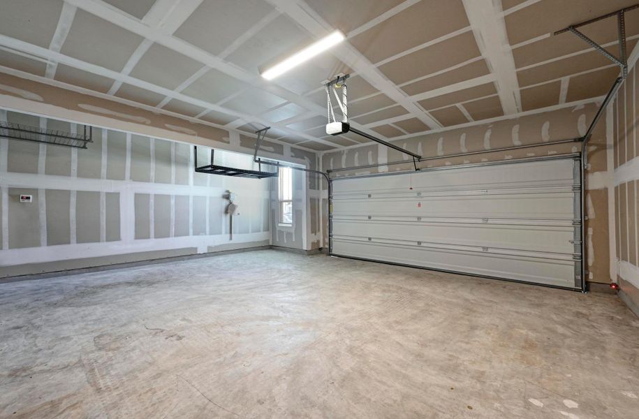 2.5 car garage with additional storage space, automatic sprinkler, and water softener loop.