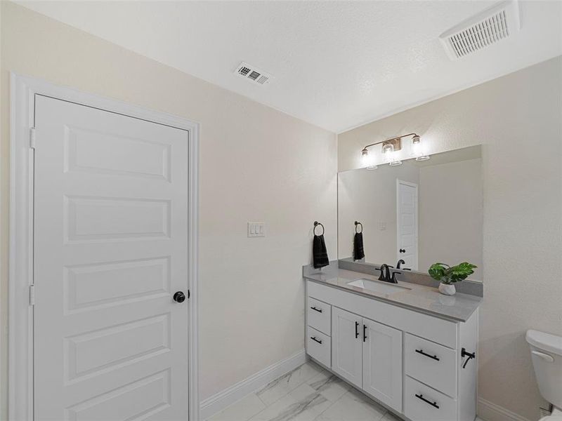 Bathroom with vanity and toilet