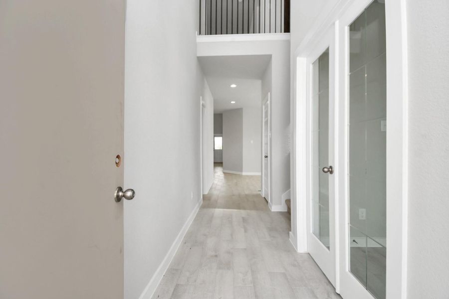 As you step into the threshold of this luxurious home, you'll soon be welcomed by an elegant glass door (to be installed). Inside, soaring ceilings amplify the spaciousness, while the refined wood-look tile flooring and oversized baseboards exude sophistication and charm Sample photo of completed home with similar floor plan. Actual colors and selections may vary. As you step into the threshold of this luxurious home, you'll soon be welcomed by an elegant glass door (to be installed). Inside, soaring ceilings amplify the spaciousness, while the refined wood-look tile flooring and oversized baseboards exude sophistication and charm Sample photo of completed home with similar floor plan. Actual colors and selections may vary.