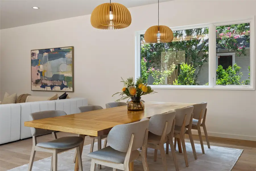 Dining room with light wood-type flooring and recessed lighting