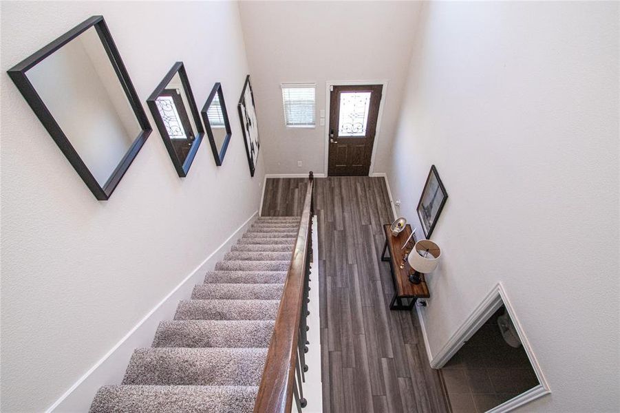 Stairs with wood finished floors and a high ceiling Stairs with wood finished floors and a high ceiling