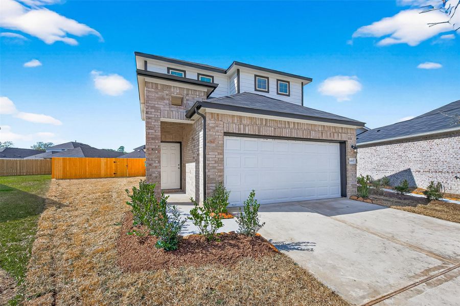 Front exterior of a new home in Woodland Lakes, Houston, TX, highlighting curb appeal (Image 19).