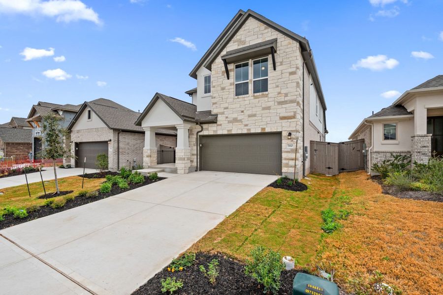 Front exterior of a new home in Flora, Hutto, TX, highlighting curb appeal (Image 23).