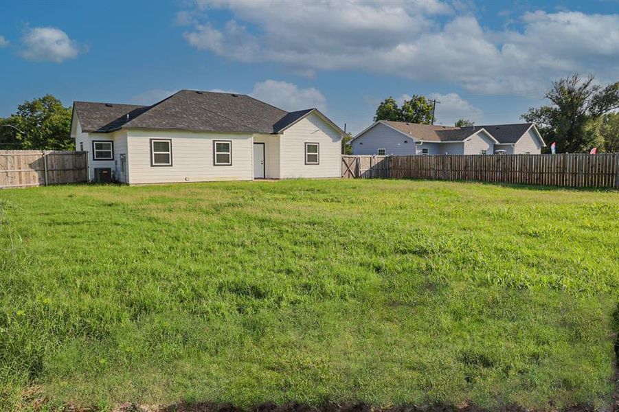 Back of property with a fenced backyard