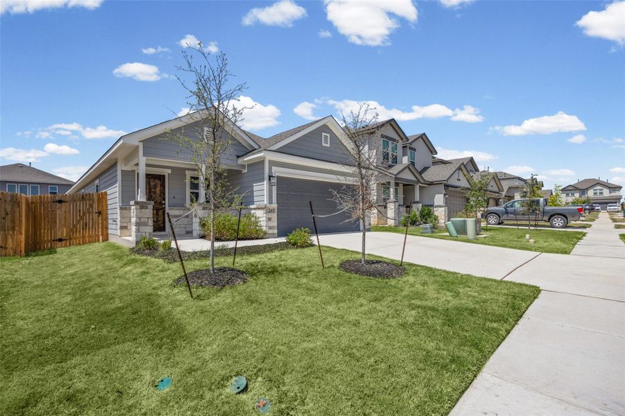A well-manicured green lawn and concrete driveway lead to the charming front entry. A well-manicured green lawn and concrete driveway lead to the charming front entry.