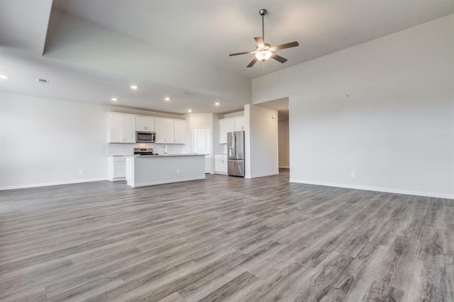 Unfurnished living room featuring light wood-style flooring, recessed lighting, and a ceiling fan