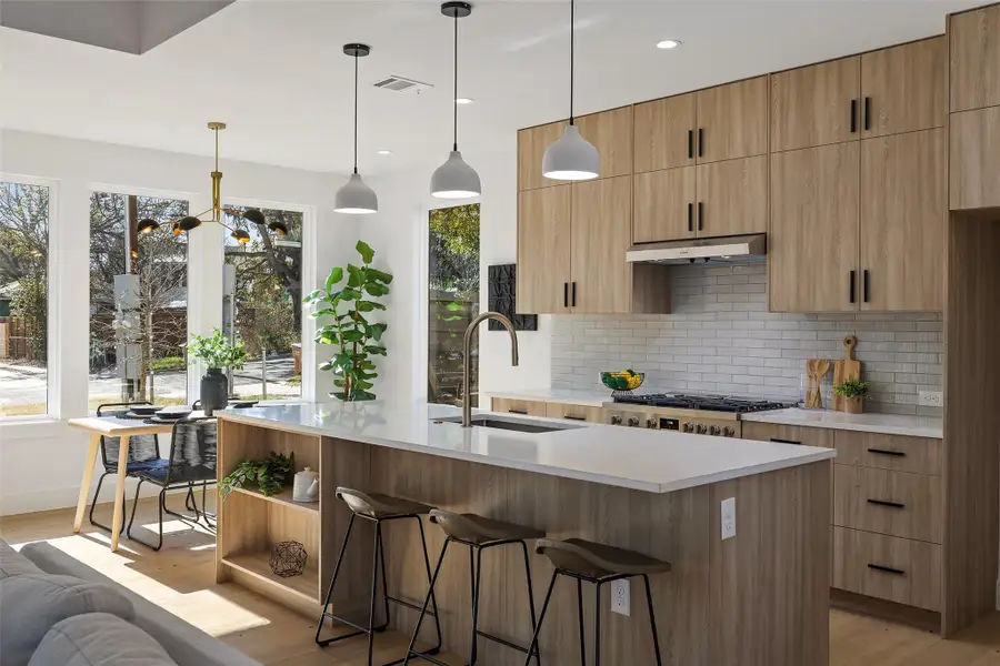 Dining area with light hardwood / wood-style floors, sink, and plenty of natural light