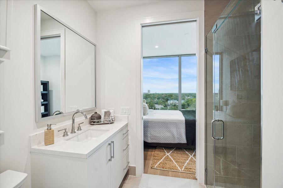 En-suite guest bathroom with glass in-framed walk-in shower. En-suite guest bathroom with glass in-framed walk-in shower.