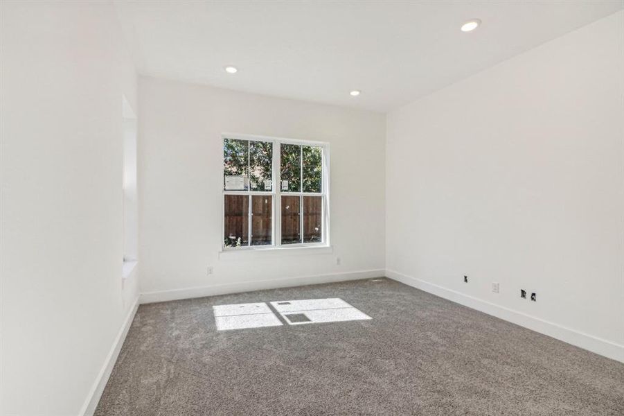 Carpeted empty room with recessed lighting
