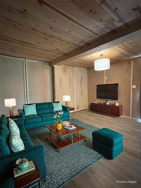 Living area featuring wooden ceiling with exposed beams