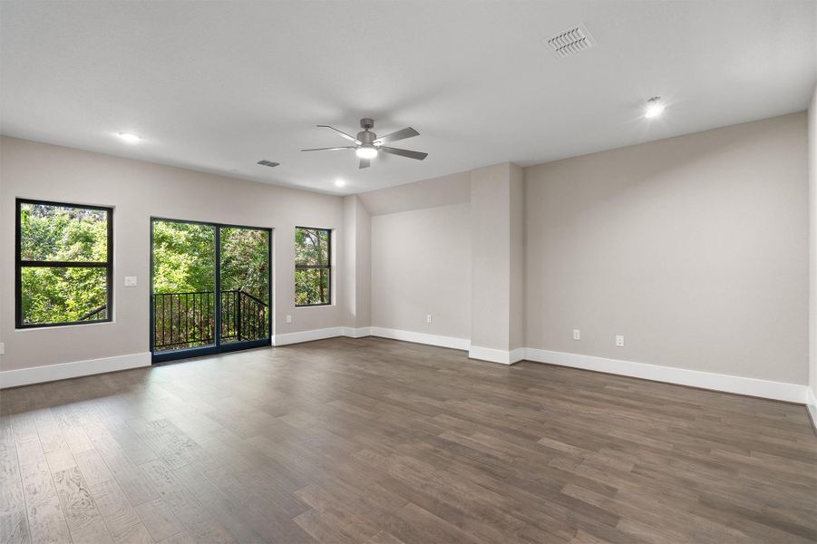 A spacious room with rich hardwood floors, abundant natural light, and a private balcony for outdoor enjoyment. A spacious room with rich hardwood floors, abundant natural light, and a private balcony for outdoor enjoyment.