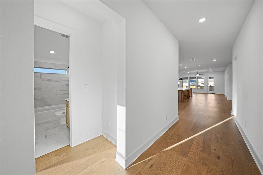 Corridor featuring recessed lighting and light wood-style floors Corridor featuring recessed lighting and light wood-style floors