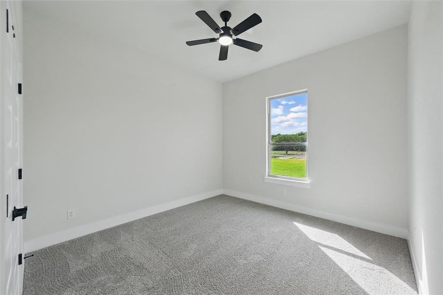 Spare room featuring carpet flooring, baseboards, and a ceiling fan Spare room featuring carpet flooring, baseboards, and a ceiling fan