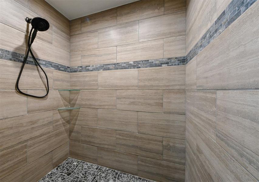 Walk-in shower in main bedroom bath. Custom tile.