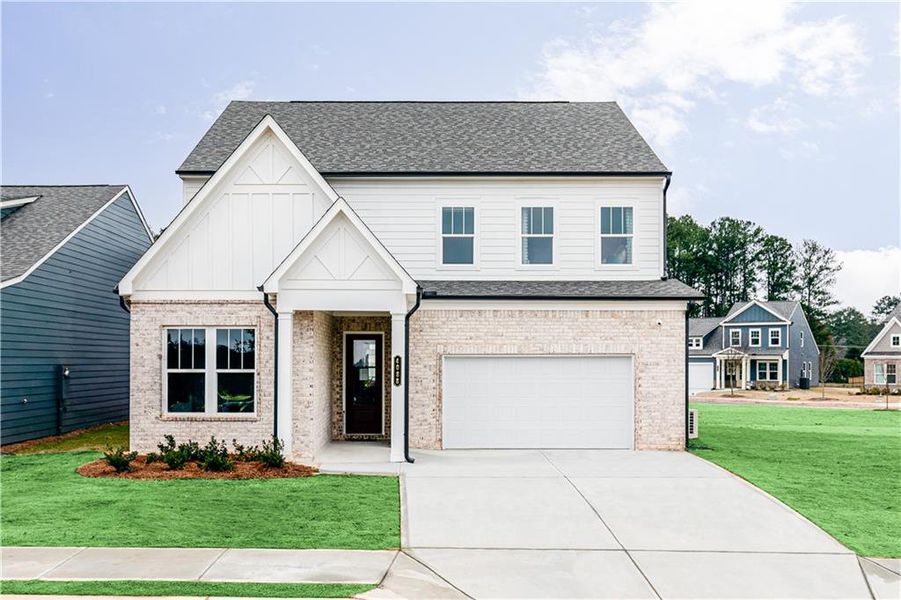 Front exterior of a new home in Annsbury Park, Lilburn, GA, highlighting curb appeal (Image 1).