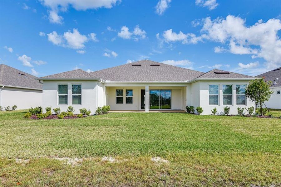 Exterior details and patio area of a home in Ardisia Park, New Smyrna Beach (Image 2).