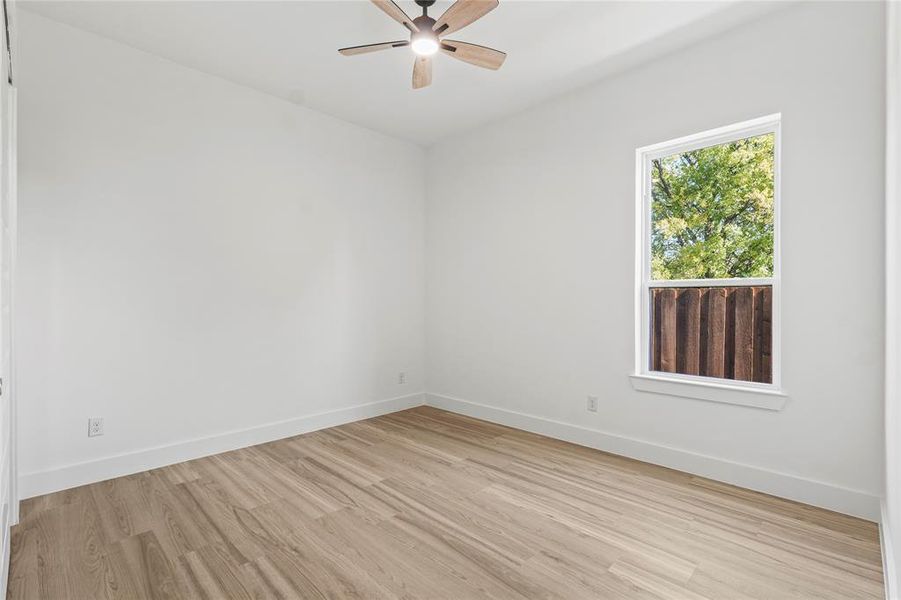 Spare room with light wood-style floors and ceiling fan