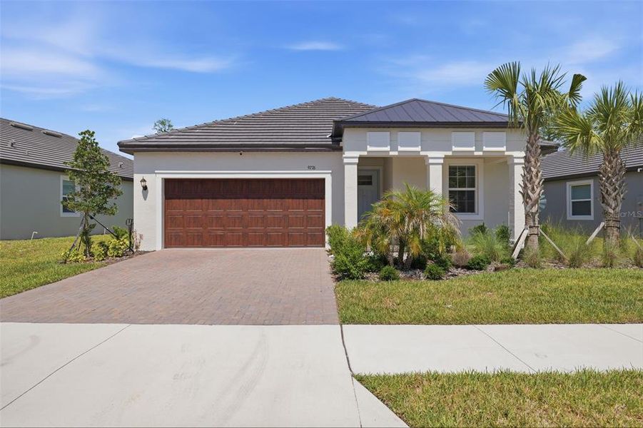 Front exterior of a new home in Angeline Active Adult, Land O' Lakes, FL, highlighting curb appeal (Image 23).