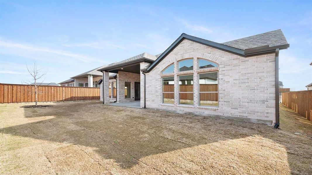 Rear view of property featuring a patio area