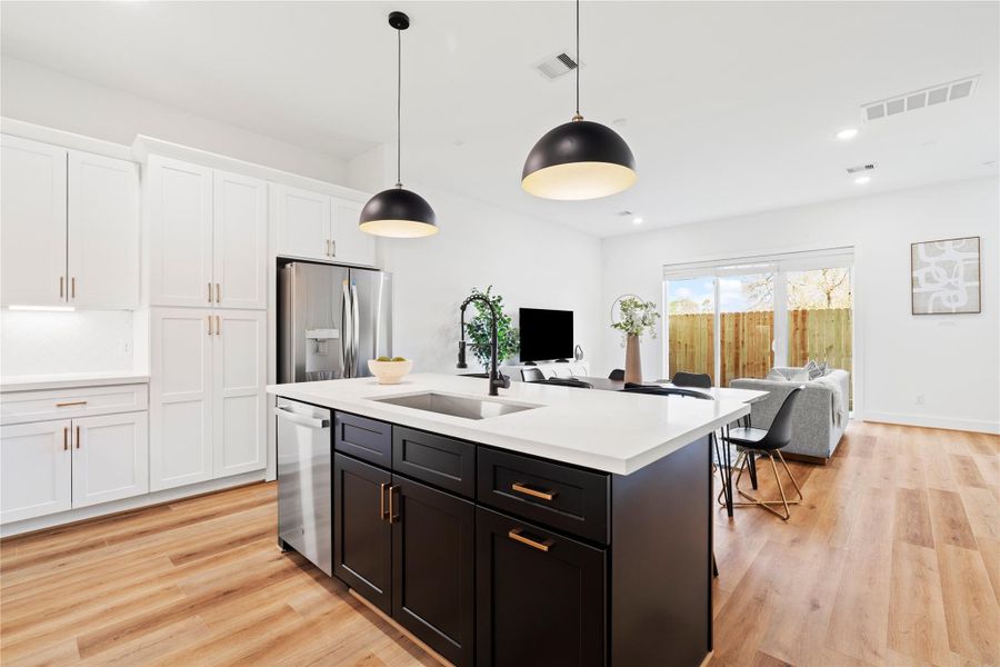 Sleek & Modern Open-Concept Living! This beautifully designed space features a stylish two-tone kitchen, oversized island, and seamless flow into the bright living and dining areas.