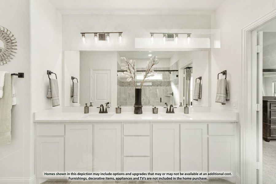 Bathroom with double vanity, white cabinets, large mirror, and two light fixtures above sinks Bathroom with double vanity, white cabinets, large mirror, and two light fixtures above sinks