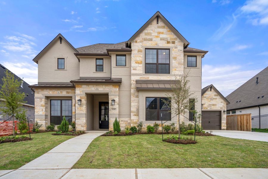 Front exterior of a new home in Jordan Ranch 70' Lots, Fulshear, TX, highlighting curb appeal (Image 2). Front exterior of a new home in Jordan Ranch 70' Lots, Fulshear, TX, highlighting curb appeal (Image 2).
