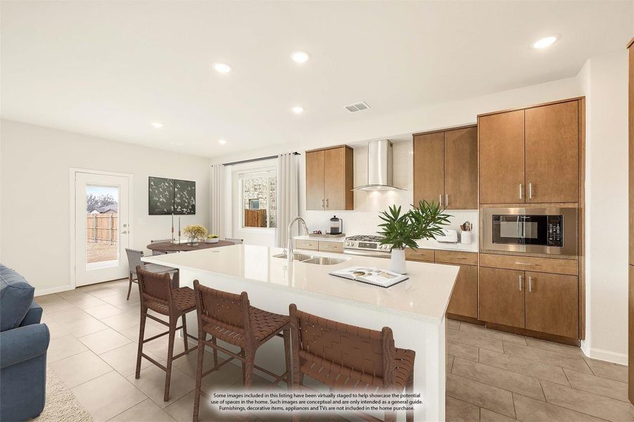 Open kitchen with large white island, wood cabinets, stainless appliances, and bar seating for three Open kitchen with large white island, wood cabinets, stainless appliances, and bar seating for three