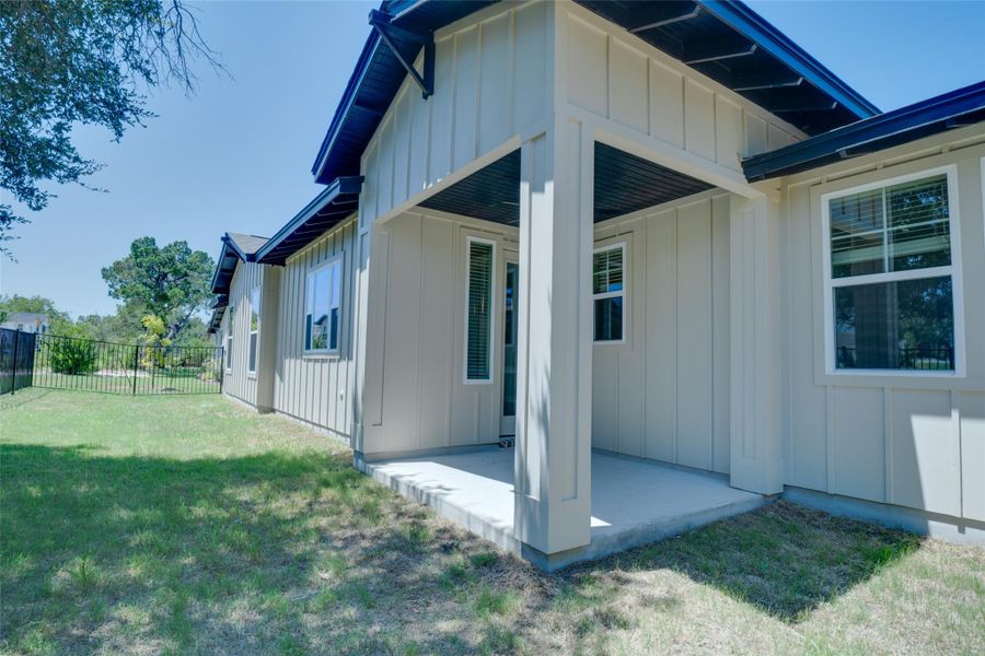 View of side of home featuring a patio area and a yard