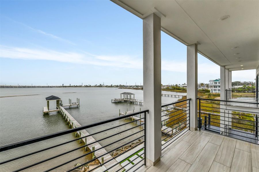 The upper balcony places the horizon directly in view. With the private pier below and open water stretching beyond, it offers an unforgettable setting for coffee, cocktails, or quiet reflection. Outdoor furnishings could transform it into a private waterfront lounge. The upper balcony places the horizon directly in view. With the private pier below and open water stretching beyond, it offers an unforgettable setting for coffee, cocktails, or quiet reflection. Outdoor furnishings could transform it into a private waterfront lounge.